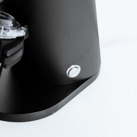 Close-up of the power button on the DF54 Electric Coffee Grinder by Earl, highlighting its sleek design and functionality.