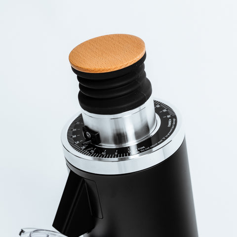 Top view of the DF54 Coffee Grinder by Earl, showcasing the wooden lid and precision grind setting dial.