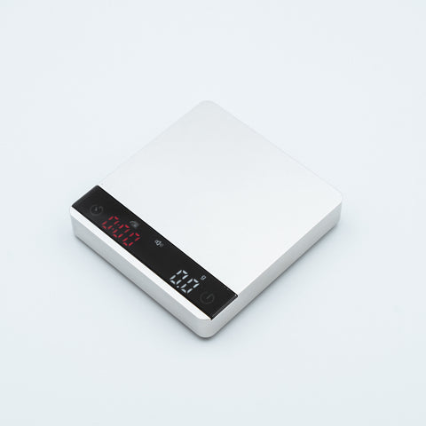 white Earl Nano Metal Coffee Scales in metallic style finish, with espresso weighing scale
