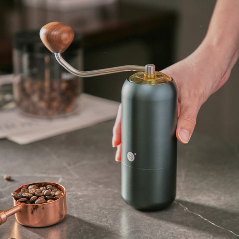 the zeroHero Z7 Coffee Hand Grinder in green with ergonomic solid wood handle