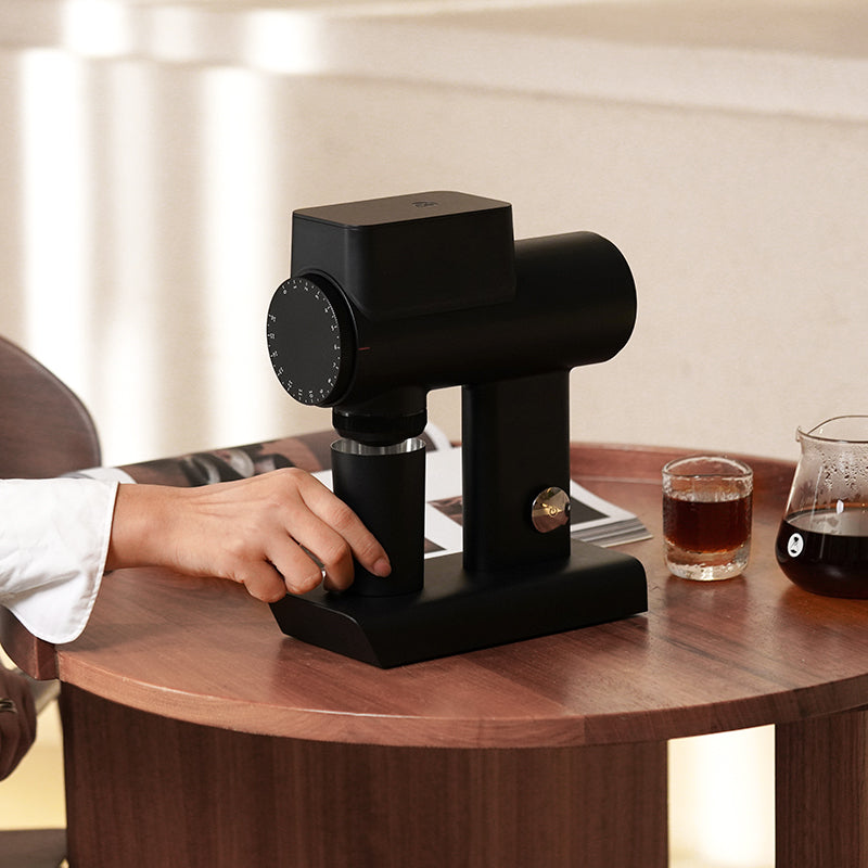 image of Timemore Sculptor 064S Electric Grinder on brown coffee table