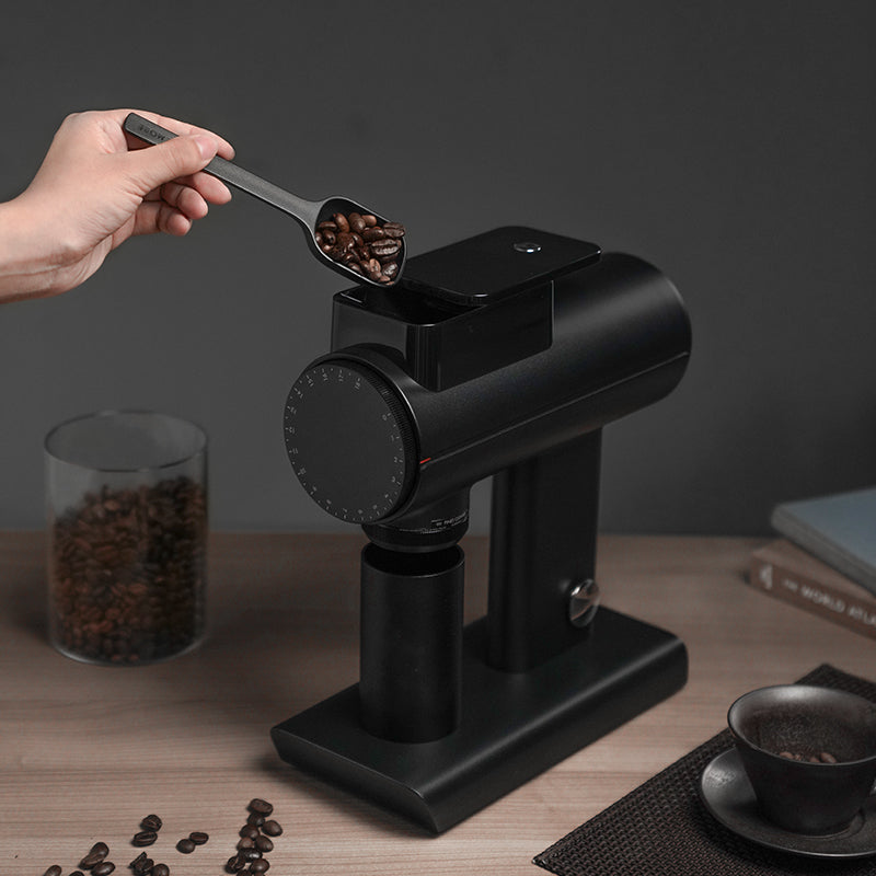 person pouring coffee beans into the Timemore Sculptor 078S Electric Grinder