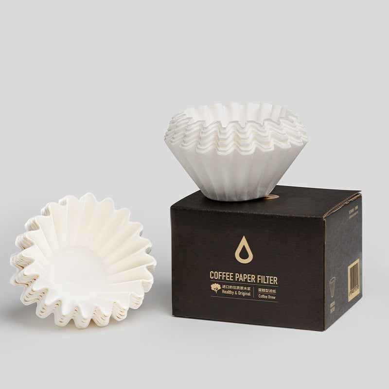 White coffee paper filters on a black box with brand details on a light gray background