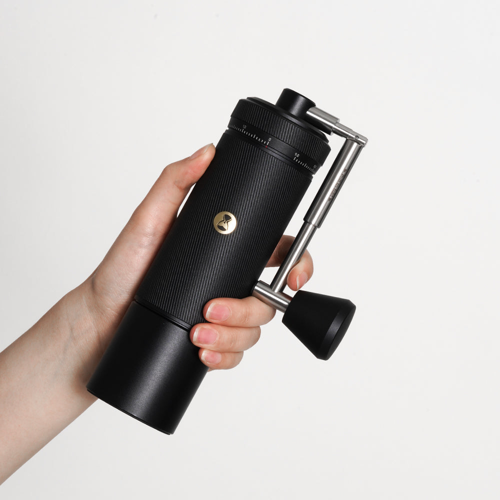 hand holding black Timemore S3 Chestnut Manual Grinder