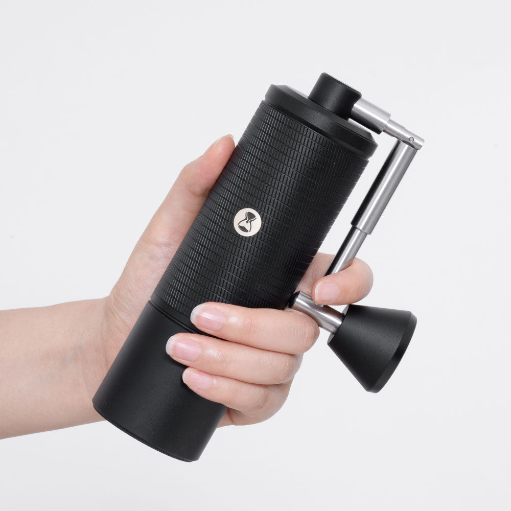 hand holding the Timemore C5 Pro Chestnut Manual Grinder showing portability and size