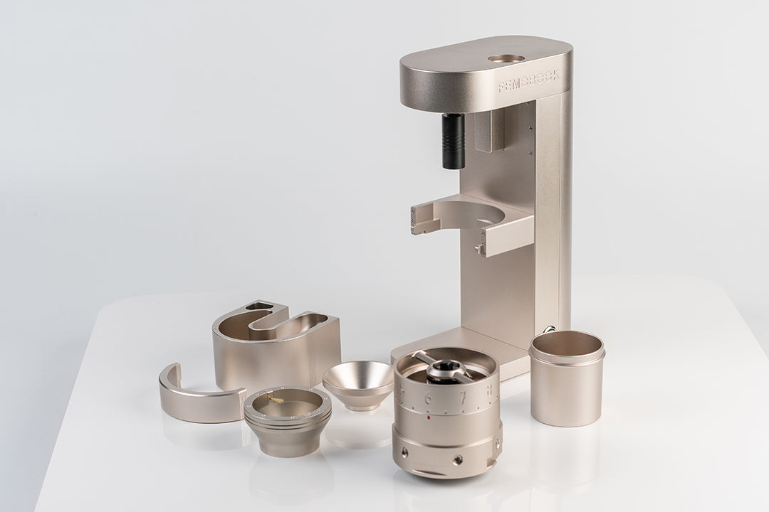metallic components of the Femobook A68 Electric Grinder laid out on white background