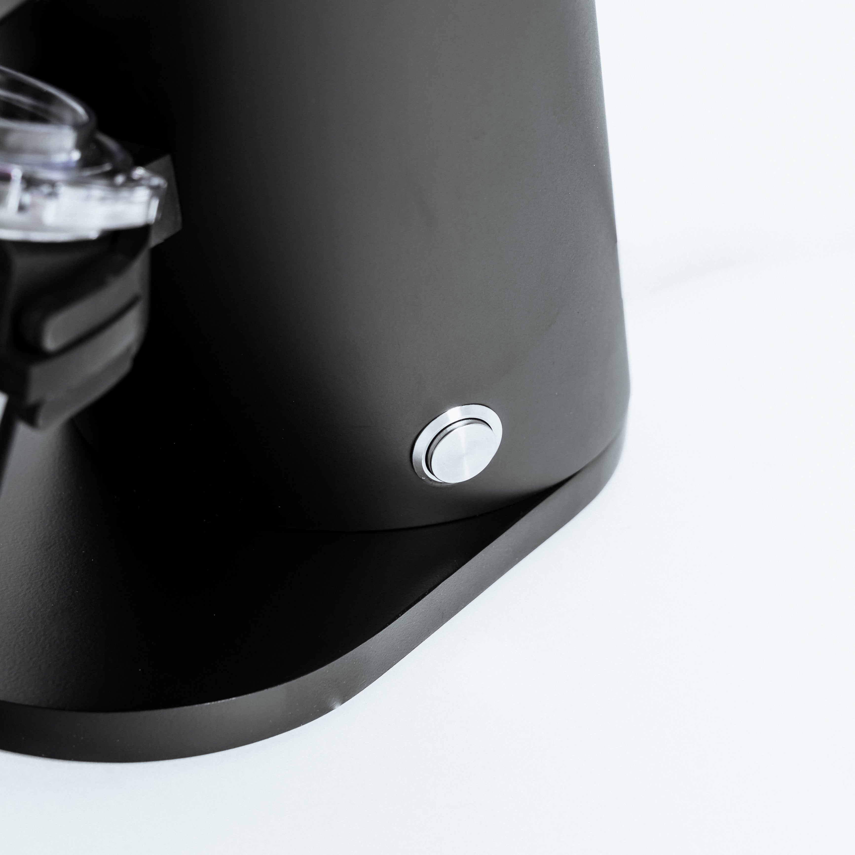 Close-up of the power button on the DF54 Electric Coffee Grinder by Earl, highlighting its sleek design and functionality.