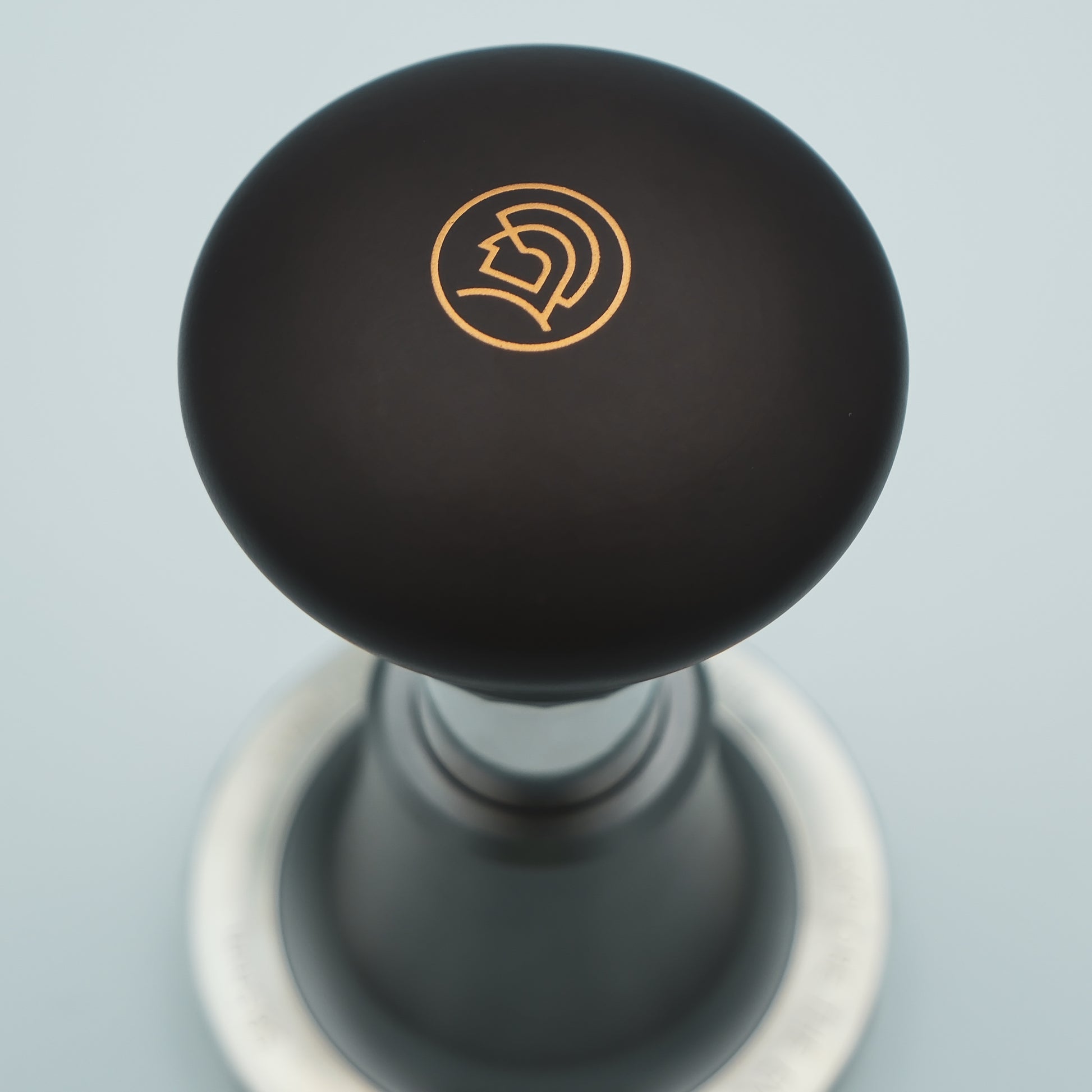 logo detailing on top of the zeroHero Sword Espresso Impact Tamper