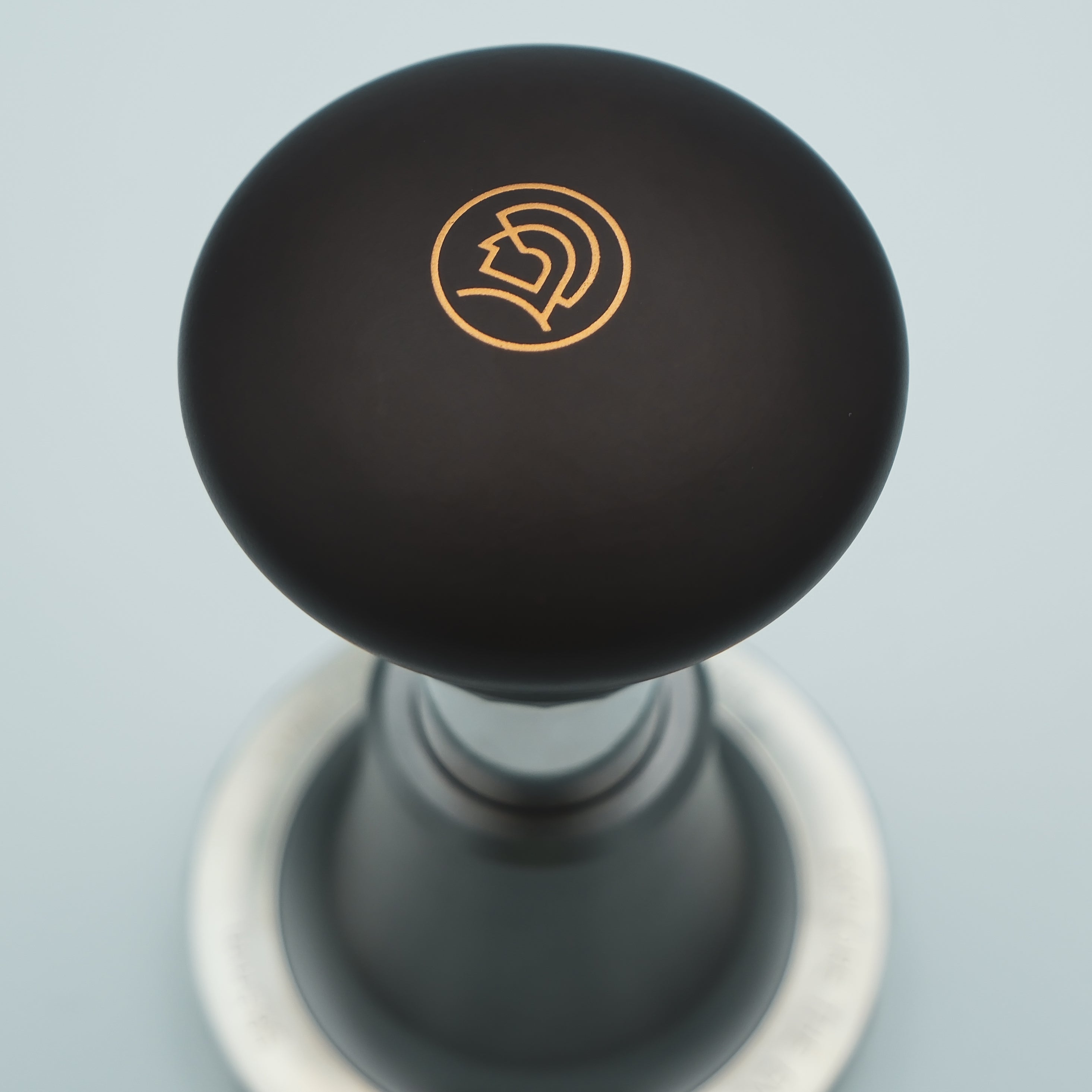 logo detailing on top of the zeroHero Sword Espresso Impact Tamper