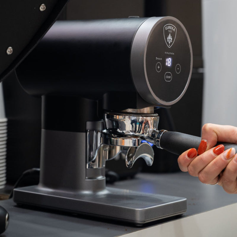 image of Eureka Disko Automatic Tamper in use on worktop