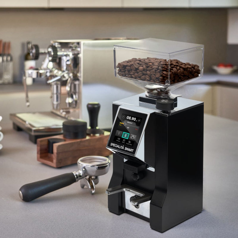 image of image of the Eureka Mignon Specialita Smart Coffee Grinder on kitchen work surface filled with coffee beans